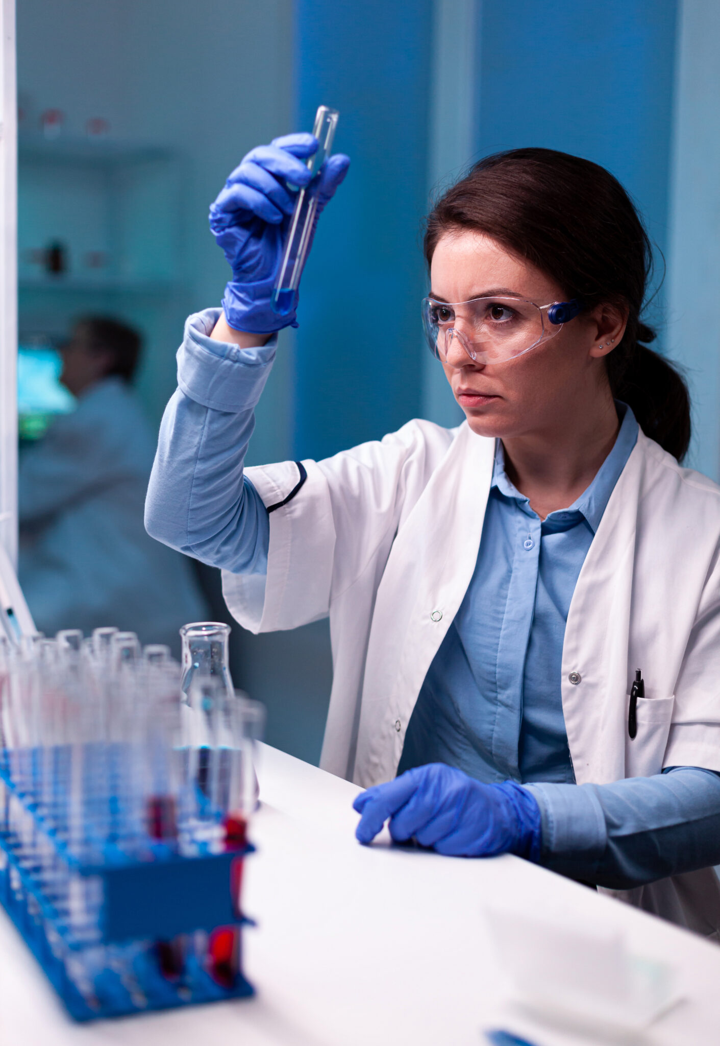 Scientist chemist analyzing a liquid sample and discovering genetic infection. Pharmaceutical biotechnologist in research laboratory works with test tube to find vaccine glove.