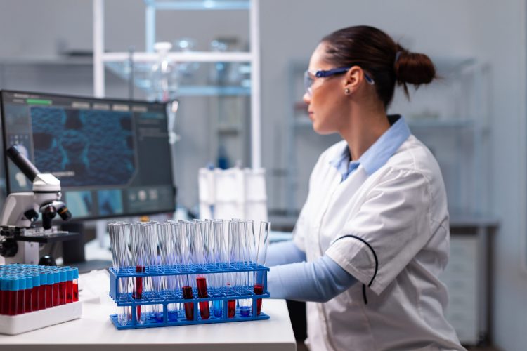 Chemist woman doctor developing virus vaccine working at pharmaceutical medical expertise in biochemistry researcher hospital laboratory. Scientist typing infection expertise on computer
